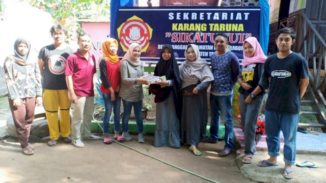 Penyerahan buku secara simbolis oleh Dekan Fakultas Ilmu Sosial dan Ilmu Politik (Fisip) Universitas Indonesia Timur (UIT) kepada Ketua Karang Taruna Desa Sikatutui, Mardi, Sabtu (29/06/2019).