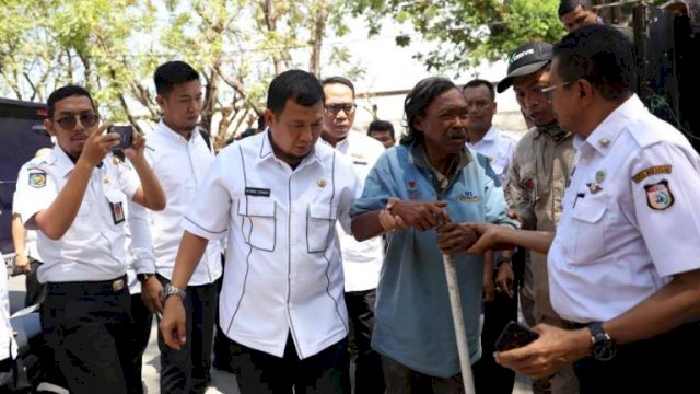 Penjabat Wali Kota Makassar Iqbal Suhaeb menggandeng Sumarno seorang Gelandangan dan Pengemis yang terjaring Dinas Sosial Makassar, Rabu (28/08/2019).