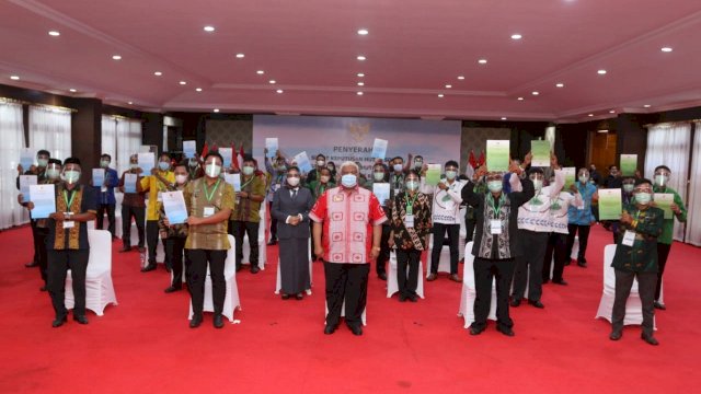 Gubernur Sultra Ali Mazi bersama sejumlah perwakilan warga dalam acara penyerahan SK Hutan Sosial dan SK TORA . Foto: Kominfo Sultra