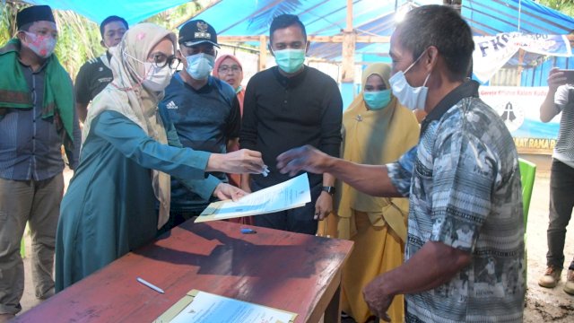 Bupati Luwu Utara, Indah Putri Indriani menyerahkan kunci hunian kepada salah satu korban banjir bandang di Dusin Panampung. Jumat (19/03/2021)