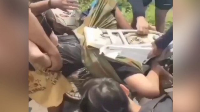 Tangkapan layar video pria yang terjepit di motornya.