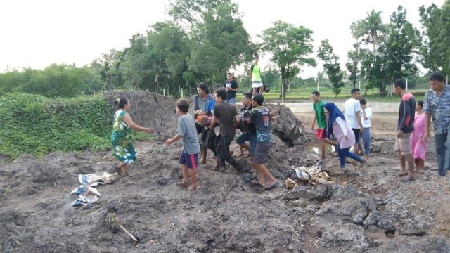 Warga mengevakuasi Jenazah pekerja Proyek Embung di Keluarahan Kalabbirang Kecamatan Pattallassang Kabupaten Takalar, Sabtu (18/12/2021).