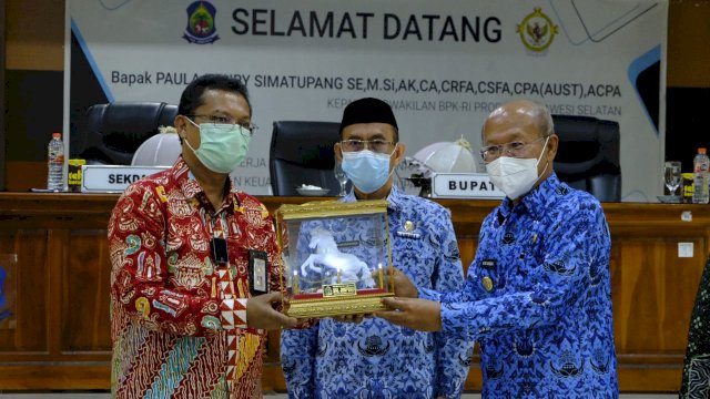 Bupati Jeneponto Iksan Iskandar, menyerahkan cendera mata kepada Kepala BPK RI PerwakilN Sulsel Paula Henry Simatupang, Kamis (10/02/2022). (Foto. Humas Pemkab Jeneponto)