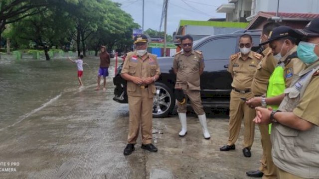 Bupati Jeneponto Iksan Iskandar, meninjau lokasi titik Banjir di Jalan Poros Jeneponto-Bantaeng tepatnya di Depan Pasar Karisa, Senin (21/02/2022). (Foto. Humas Pemkab Jeneponto)