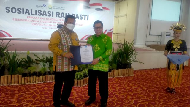 Bupati Muna Laode Muhammad Rusman Emba, saat menerima piagam penghargaan dari Kepala BKBBN RI, Hasto Wardoyo di Kota Kendari, Jumat (25/03/2022). (Istimewa)