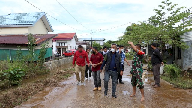 Bupati Luwu Timur, H. Budiman, meninjau langsung lokasi banjir yang terjadi di Perumahan Bumi Batara Guru, Desa Ussu, Kecamatan Malili, pada hari Jumat (11/03/2022).