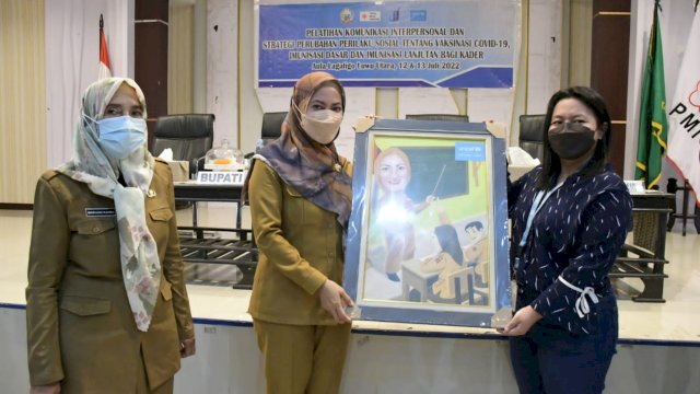 Bupati Luwu Utara Indah Putri Indriani, menerima cendera mata dari UNICEF Indonesia saat membuka pelatihan Komunikasi Perilaku Sosial Tentang Vaksinasi Covid-19 di Aula Laga Ligo kantor Bupati Luwu Utara, Selasa (12/07/2022). (Istimewa)