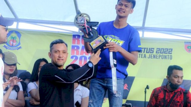 Wakil Bupati Jeneponto Paris Yasir, memberikan piala ke juara Road race Bupati Cup III. (Ist)
