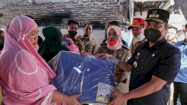 Gubernur Sulsel Andi Sudirman Sulaiman, saat menyerahkan bantuan secara simbolis ke salah sagu korban kebakaran di Rappokalling, Kota Makassar, Selssa (27/09/2022). (Istimewa)