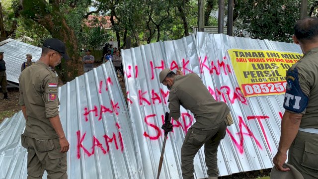 Aparat Satpol PP saat membuka aset milik Pemprov Sulsel yang diklaim oleh perorangan sebagai milik pribarinya. (Istimewa)