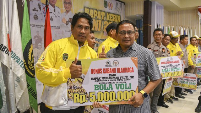 Anggota Komisi V DPRRI Fraksi Golkar, Muhammad Fauzi menyerahkan bonus kepada salah satu pengurus cabang olahraga peraih medali pada ajang Poprov XVII 2022 di Aula Lagaligo Kantor Bupati Luwu Utara. Sabtu (24/12/2022)