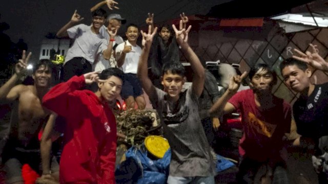 Moment saat sekelompok Pemuda di Kelurahan Barombong, Kota Makassar, berfoto gembira saat mengangkut sampah usai bersihkan di Got yang tersumbat. (Istimewa)