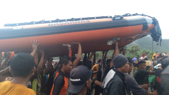 Pulihan warga bergotong royong mengangkat perahu karet untuk mencarinkorban tenggelam di Pantai Lere, Kabupaten Bima. (Istimewa)
