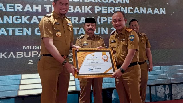 Bupati Gowa Adnan Purichta Ichsan didampingi Wakilnya Abd. Rauf Malaganni, dan Kepala Bappeda Kabupaten Gowa Sujjadan saat menyerahkan piagam penghargaan Perangkat Daerah Terbaik Pertama untuk Penyusunan Dokumen Renja-PD kepada Kepala Bapenda Kabupaten Gowa Indra Wahyudi Yusuf, di sela-sela (Musrenbang Kabupaten Gowa 2023 untuk Penyusunan RKPD Tahun 2023, di Living Plaza Hertasning, Jalan Tun Abdul Razak, Selasa (14/03). (Chaerani/Republiknews.co.id)