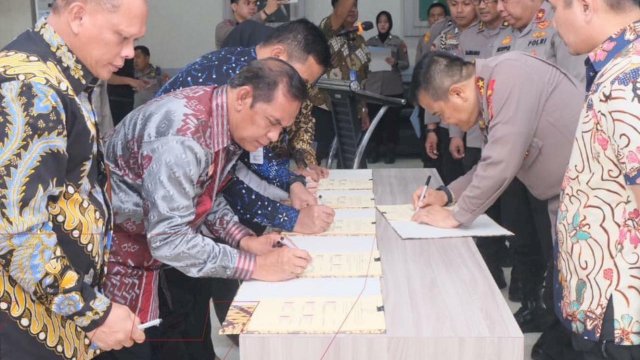 Kepala Divisi Pemasyarakatan Kanwil Kemenkumham Sulsel Suprapto mewakili Kakanwil Kemenkumham Sulsel Liberti Sitinjak saat melakukan penandatanganan kesepakatan bersama tentang Satgas TPPO, di Lobby Lontang Addupangeng Bharadaksa, Mapolda Sulsel, Jumat, (23/06/2023). (Dok. Humas Kanwil Kemenkumham Sulsel)