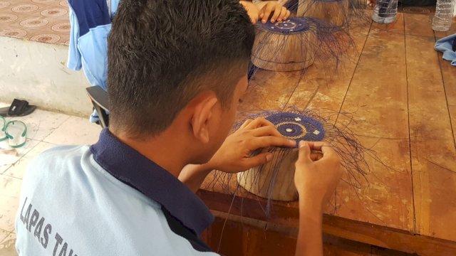 Warga binaan Lapas Takalar saat menganyam songkok. Produksi kerjasama khas warga binaan ini semakin diminati masyarakat. (Dok. Humas Kanwil Kemenkumham Sulsel)