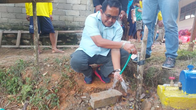 Anggota Komisi V DPR RI Muhammad Fauzi mengecek langsung kualitas air dari Pamsimas yang ada di Dusun Kumbari, Desa Sassa, Kecamatan Baebunta. Kamis (4/1/2023)