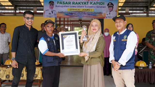 Bupati Luwu Utara Indah Putri Indriani bersama kepala UPT Pasar memegang sertifikat dan piala Pasar Kapidi menjadi Juara I Nasional Pasar Pangan Aman Berbasis Komunitas (PPABK) Regional Tengah tahun 2024. (ist)