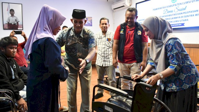 Bupati Luwu Utara menyerahkan alat bantu berupa kursi roda kepada salah satu penyandang disabilitas di Luwu Utara.(ist)