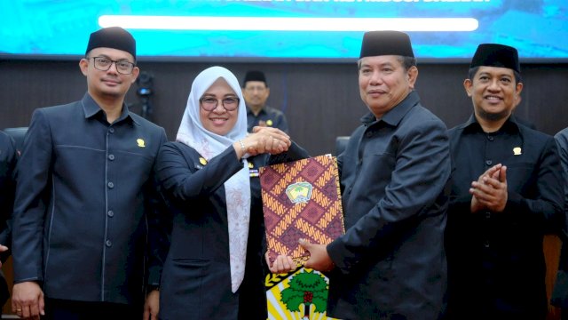 Bupati Gowa, Sitti Husniah Talenrang saat menerima draft peraturan daerah terkait upaya peningkatan PAD yang diberikan Ketua DPRD Kabupaten Gowa, Muh Ramli Sidik, dalam Rapat Paripurna DPRD Kabupaten Gowa, di Ruang Rapat Paripurna Kantor DPRD Gowa, kemarin. (Dok. Humas Gowa) 