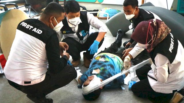 Simulasi saat tim memberikan pertolongan pertama dengan membalut luka pada kepala korban dalam simulasi tanggap darurat yang digelar PLN UIP Sulawesi, Senin, (05/10/2026). (Dok. Humas PLN UIP Sulawesi) 